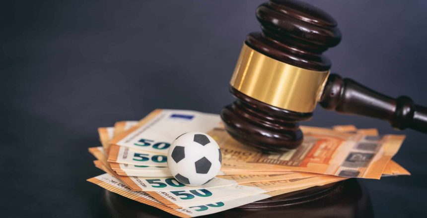 Judge gavel, football soccer ball and euro banknotes on black background