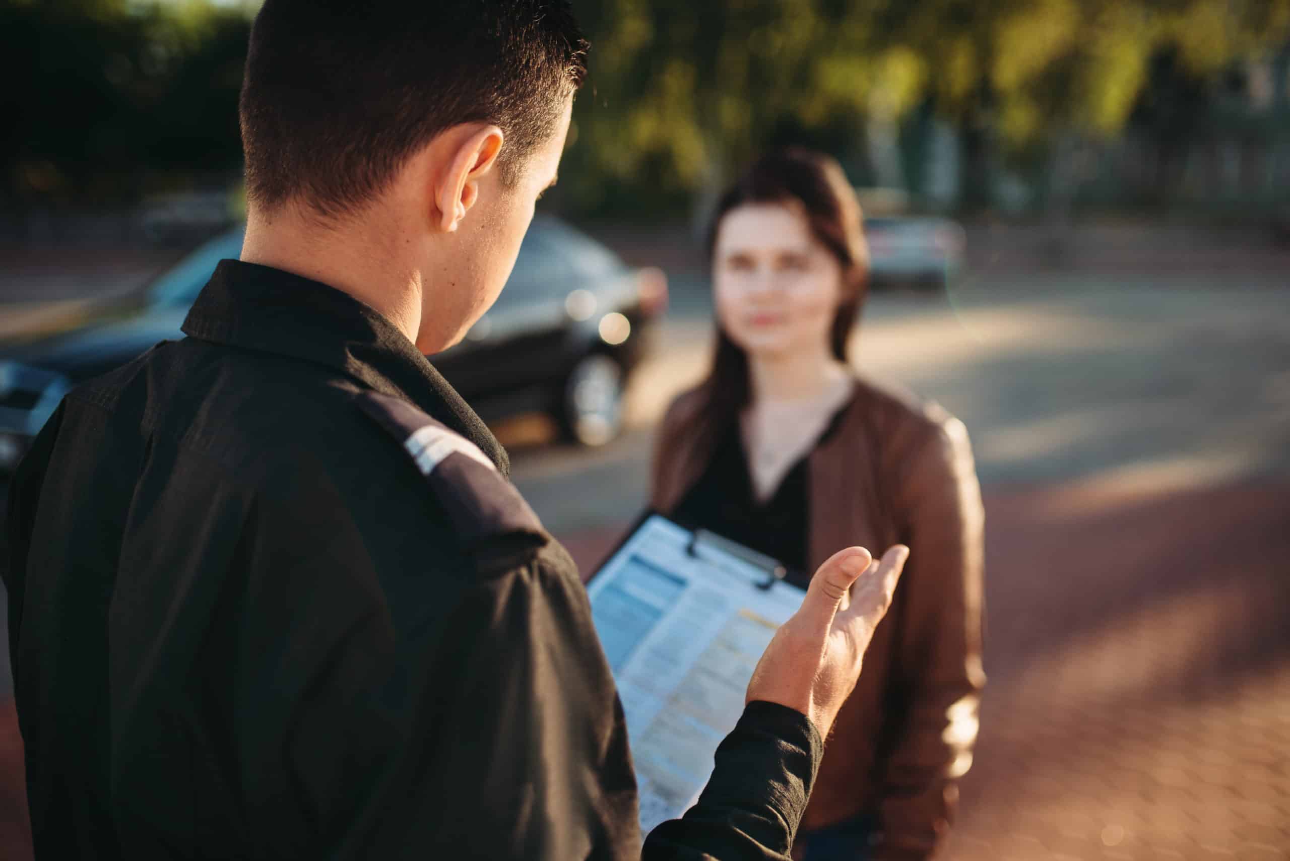 Police officers in uniform reads law to female driver. Law protection, car traffic inspector, safety control job